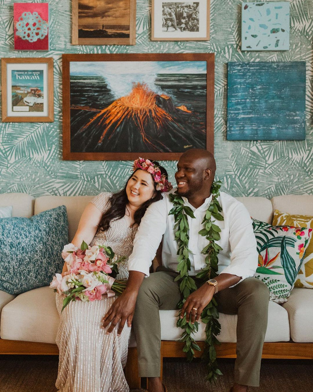 A bride wearing a haku lei and holding a bouquet designed by SF. Fleur and the groom wearing a maile lei seated at the Kaimana hotel