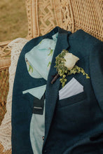 Load image into Gallery viewer, Closeup of a white rose boutonniere pinned to a navy jacket
