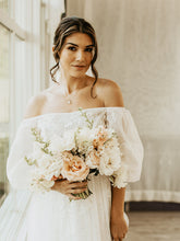 Load image into Gallery viewer, A bride holding a bouquet of ruffled tulips and white roses

